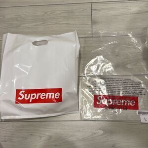 Supreme white plastic shopping bag with red box logo and clear bag with red supr
